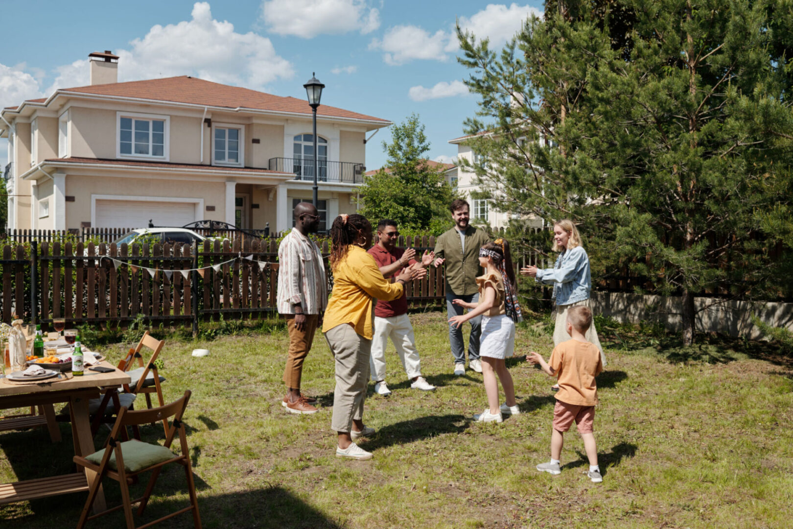 Family playing outside near a suburban house.
