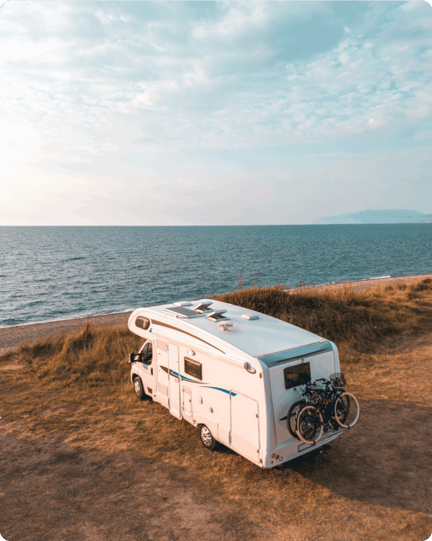 Campervan parked by the sea shore.